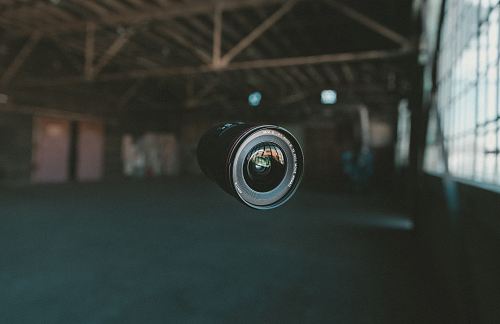 selective focus photography of black zoom lens on mid air